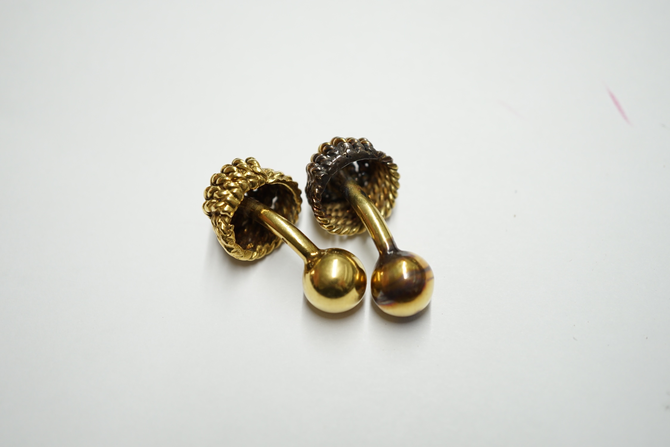 A French 18ct gold cufflink of rope twist design with ball terminals, 9.4 grams and an unmarked companion. Condition - fair